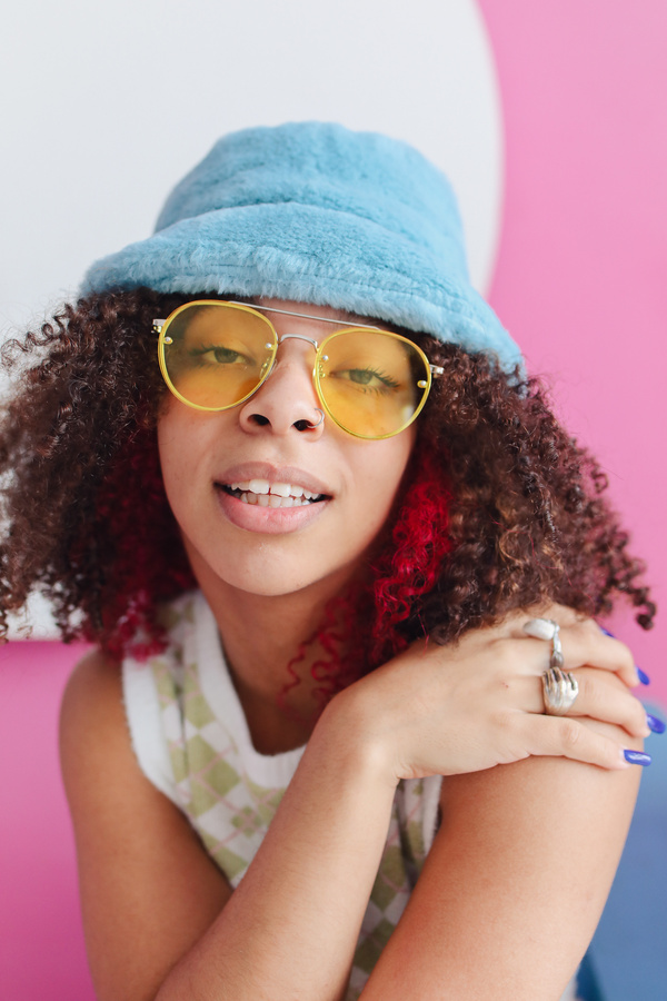 Portrait of a Woman in Sunglasses and Bucket Hat